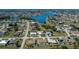Aerial view of a lakeside community featuring well-maintained homes with pools and green spaces at 26089 Templar Ln, Punta Gorda, FL 33983