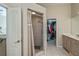 Bathroom featuring a walk-in shower and closet, bright lighting, white tiling, and vanity on the right at 26089 Templar Ln, Punta Gorda, FL 33983