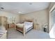 Spacious bedroom featuring a comfortable bed, ceiling fan, and sliding glass door leading to the backyard at 26089 Templar Ln, Punta Gorda, FL 33983