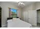 Bedroom with a cozy bed, ceiling fan, and window with a view of the backyard at 26089 Templar Ln, Punta Gorda, FL 33983