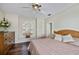 Bedroom featuring a ceiling fan and a window with plantation shutters at 26089 Templar Ln, Punta Gorda, FL 33983