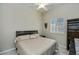 Neutral bedroom with a ceiling fan, window with shutters, and dark-stained furniture at 26089 Templar Ln, Punta Gorda, FL 33983