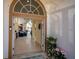 Inviting foyer view into a living room and screened pool area at 26089 Templar Ln, Punta Gorda, FL 33983