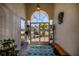 Bright and airy foyer with decorative rug, bench, and stylish front doors at 26089 Templar Ln, Punta Gorda, FL 33983