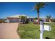 Charming single-story home with beautiful landscaping, a paved driveway, and a well-maintained lawn at 26089 Templar Ln, Punta Gorda, FL 33983