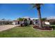 Well-maintained single-story home with a lush lawn, mature landscaping, and a prominent palm tree at 26089 Templar Ln, Punta Gorda, FL 33983