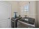 Laundry room featuring a window with plantation shutters at 26089 Templar Ln, Punta Gorda, FL 33983