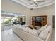 Spacious living room with an open concept that flows to the outdoor pool and a comfortable sectional couch at 26089 Templar Ln, Punta Gorda, FL 33983