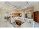 The open-concept living area features a kitchen, dining area, and large sectional, perfect for entertaining at 26089 Templar Ln, Punta Gorda, FL 33983