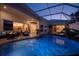 Inviting screened-in pool area with elegant seating, fire pit, and spa, perfect for outdoor relaxation at 26089 Templar Ln, Punta Gorda, FL 33983