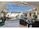 The pool area has a spa, lush plants, seating area, and a screened enclosure for an outdoor retreat at 26089 Templar Ln, Punta Gorda, FL 33983