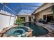Beautiful pool area with a hot tub and lush tropical plants, perfect for relaxation and entertainment at 26089 Templar Ln, Punta Gorda, FL 33983