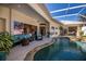 Inviting backyard with a sparkling pool, patio seating, and lush landscaping, perfect for outdoor living at 26089 Templar Ln, Punta Gorda, FL 33983