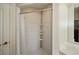 Walk-in shower features tiled walls and built-in shelving for ample storage at 26089 Templar Ln, Punta Gorda, FL 33983