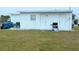 Property backyard featuring a lawn, outdoor barbecue and backyard storage for homeowner convenience at 3116 Crestwood Dr, Port Charlotte, FL 33952