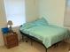 Simple bedroom with tile floors, a comfortable bed, and a functional bedside table at 3116 Crestwood Dr, Port Charlotte, FL 33952