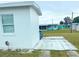 Property featuring a manicured lawn, complemented by the home's simple design and a well-kept garden area at 3116 Crestwood Dr, Port Charlotte, FL 33952