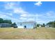 Charming single-story home with a spacious yard and clear blue skies, ideal for outdoor activities at 3116 Crestwood Dr, Port Charlotte, FL 33952