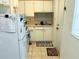 Functional kitchen with ample storage, a stainless steel sink, and practical tile flooring at 3116 Crestwood Dr, Port Charlotte, FL 33952