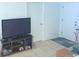 Simple living room featuring tile floors, a modern television, and a neat entertainment console at 3116 Crestwood Dr, Port Charlotte, FL 33952