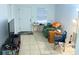 Inviting living area with tile flooring, a cozy armchair, and a convenient entertainment center at 3116 Crestwood Dr, Port Charlotte, FL 33952