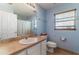 Traditional bathroom with a large mirror over the sink and a separate toilet and shower area at 312 Mendoza St, Punta Gorda, FL 33983
