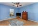 Cozy bedroom featuring a large window, a ceiling fan, and a wood dresser at 312 Mendoza St, Punta Gorda, FL 33983