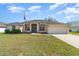 Charming single-story home with a well-manicured lawn and an attached two-car garage at 312 Mendoza St, Punta Gorda, FL 33983