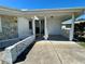 Covered front porch featuring tile flooring and a white picket fence on one side at 3415 Harbor Blvd, Port Charlotte, FL 33952