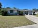 Charming single-story home with stone accents and a long driveway leading to the attached carport at 3415 Harbor Blvd, Port Charlotte, FL 33952