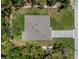 An overhead shot of a house with a grey roof, surrounded by a green lawn and lush trees at 368 Manly St, Port Charlotte, FL 33953