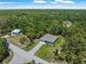 Aerial view of new construction home with paved driveway and a two car garage nestled among mature trees at 368 Manly St, Port Charlotte, FL 33953