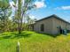 Lush backyard with a modern home featuring a clean, contemporary design and a well-maintained lawn at 368 Manly St, Port Charlotte, FL 33953