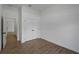 Bright bedroom with wood-style tiled floors, closet, and access to rooms via the open doorway at 368 Manly St, Port Charlotte, FL 33953