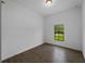 Bright bedroom featuring a window with serene outdoor views and sleek, wood-style tiled flooring at 368 Manly St, Port Charlotte, FL 33953