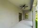 This covered patio has a ceiling fan and sliding glass doors leading to the backyard at 368 Manly St, Port Charlotte, FL 33953