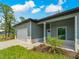 Charming home exterior with a garage, inviting front porch, and a well-manicured lawn at 368 Manly St, Port Charlotte, FL 33953