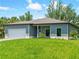 Inviting single-story home with a well-manicured lawn and attached garage at 368 Manly St, Port Charlotte, FL 33953