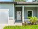 Home featuring a front entry and garage, enhanced by vibrant landscaping at 368 Manly St, Port Charlotte, FL 33953