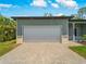 Spacious garage and driveway combination complementing the modern home's exterior facade and landscaping at 368 Manly St, Port Charlotte, FL 33953