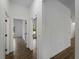 Bright hallway highlighting wood-style tiled floors and open doorways leading to bedrooms and other spaces at 368 Manly St, Port Charlotte, FL 33953