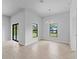 Bright living room with tile flooring, natural light, and modern light fixture at 368 Manly St, Port Charlotte, FL 33953