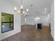 Open-concept living area with tile floors, modern lighting, and a view to the kitchen at 368 Manly St, Port Charlotte, FL 33953
