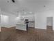 Spacious living room featuring tile floors, modern fixtures, and an island kitchen at 368 Manly St, Port Charlotte, FL 33953