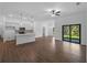 Open living space with modern kitchen, tile floors, and sliding doors leading to the backyard creates a seamless indoor-outdoor flow at 368 Manly St, Port Charlotte, FL 33953