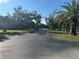 Long, paved driveway lined with mature trees and landscaping at 4072 Oakview Dr # C5, Punta Gorda, FL 33980