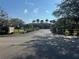 Gated community entrance with lush landscaping and mature trees at 4072 Oakview Dr # C5, Punta Gorda, FL 33980