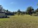 Open green space with mature trees, landscaping, and nearby parking at 4072 Oakview Dr # C5, Punta Gorda, FL 33980