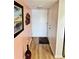Inviting hallway with wood-look floors, a decorative painting and a neutral color palette at 4072 Oakview Dr # C5, Punta Gorda, FL 33980