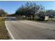 Residential street showcasing mature trees and the community's entrance sign at 4072 Oakview Dr # C5, Punta Gorda, FL 33980